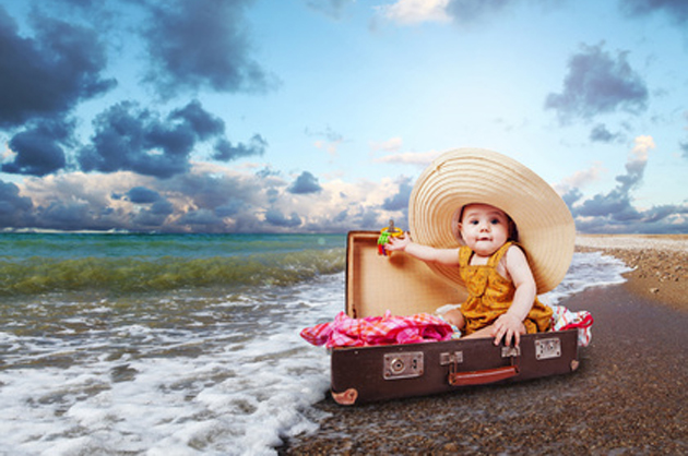 Travel concept image with baby in suitcase